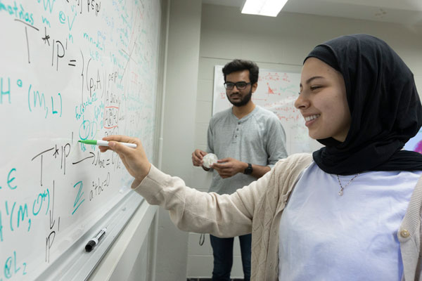 Students in front of a whiteboard