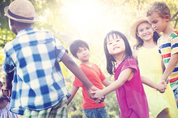 children holding hands outdoors